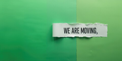 Fragmented paper with handwritten message on green surface, symbolizing change and expression, Earth Day