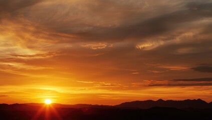Sunset scene featuring vibrant orange sky and horizon glow, ideal for background use