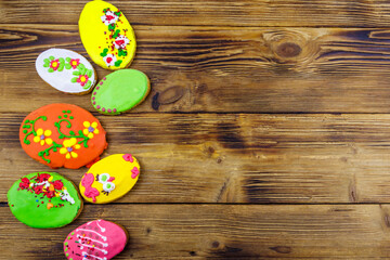 Egg shaped easter gingerbread cookies on wooden table. Top view, copy space. Sweets for celebrate Easter