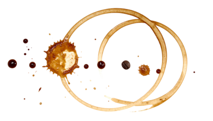 Coffee stain rings and droplets on a black background, suggesting a spilled beverage