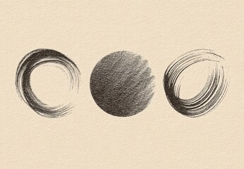 Three sketched dark circles on textured paper, two are ring-shaped