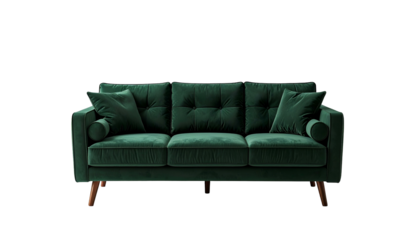 Luxurious green velvet couch, with cushions and cylindrical side bolsters, against black