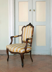 antique chair against pastel blue doorway