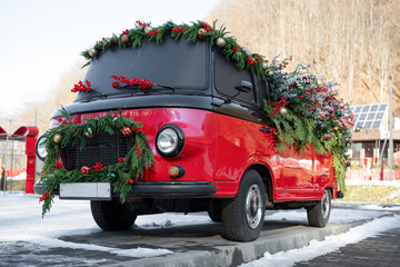 A red retro car decorated with New Year's decorations .  Christmas concept.