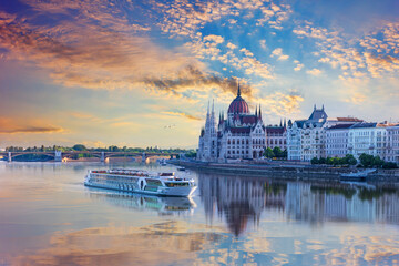 Aerial view of cruise ship and Budapest Parliament under sunrise sky, Hungary