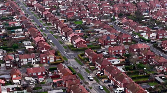Aerial drone footage of the village of Huntington in the City of York North Yorkshire England showing rows of typical British houses and housing estates with roads, streets and gardens in the winter