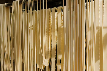 Fresh Pasta Drying On Hanging Racks In Traditional Food Production
