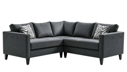 A dark gray, modern, sectional sofa with pillows against a black background