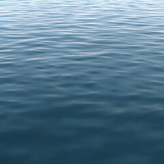 Deep blue tranquil water surface with gentle, undulating ripples creating an abstract and calming natural texture. A pristine aquatic backdrop reflecting serenity and fluid motion