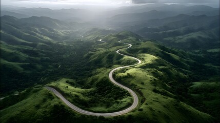 Serpentine Road Winding Through Lush Green Mountains Under Dramatic Sunlight.