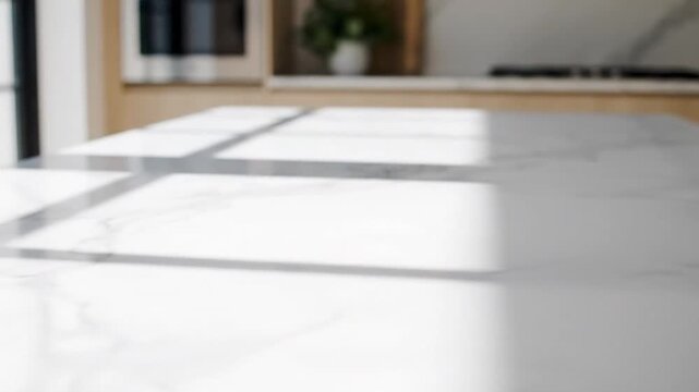 A bright kitchen showcasing a marble countertop with soft shadows and a modern design