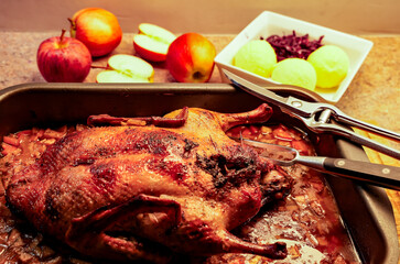 Traditional roast duck, fresh from the oven. The roast is often stuffed with apples, onions, marjoram, and mugwort. Typical side dishes are red cabbage and dumplings.