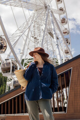 Woman standing at Ferris wheel during daytime