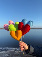beautiful colorful knitted hearts at the winter beach for Valentine&acute;s day