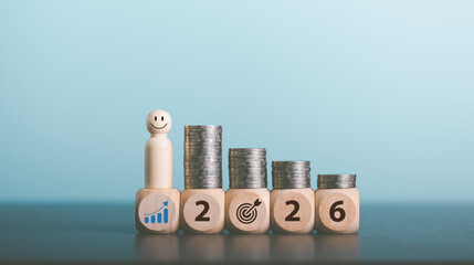 Stacks of coins with Calendar and wooden blocks forming number 2026 for target financial growth,...