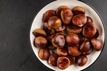Obraz premium Edible chestnuts delicious treat tasty snack fresh gourmet food background on table rustic food top view copy space