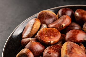 Fototapeta premium Edible chestnuts delicious treat tasty snack fresh gourmet food background on table rustic food top view copy space