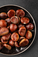 Fototapeta premium Edible chestnuts delicious treat tasty snack fresh gourmet food background on table rustic food top view copy space