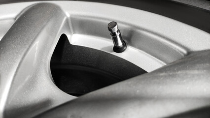 Car wheel air valve close up macro shot in a dark cinematic light