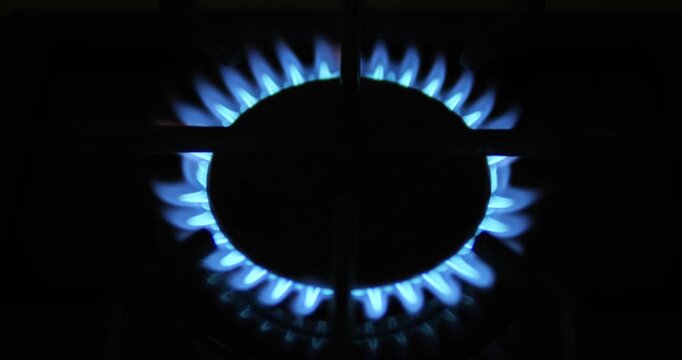Gas burner burns with a blue flame. Gas shut-off. End of energy sources.