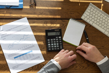 2025 tax declaration and yearly financial report, calculator and hands of business man