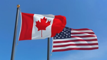 "Canada and United States National Flags Flying Together Against Clear Blue Sky Symbolizing Strong Bilateral Relations"