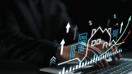Hands Typing on Laptop with Digital Graphs Displaying Real Estate Growth and Statistics in a Dark Environment Gluon.