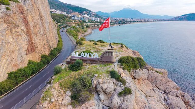 Aerial View of Alanya: 'Alanya' Sign with Castle in the Distance in 4k