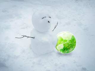 Snowman and green globe earth on white snow bckground, Wishing of the snow man for the green worm world concept