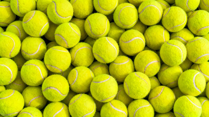 Large pile of bright yellow tennis balls stacked closely together filling frame creating textured background and pattern of sports equipment for active games