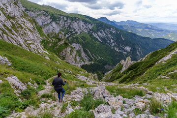 Fototapeta premium Hiker Descending Steep Rocky Trail in High Tatras