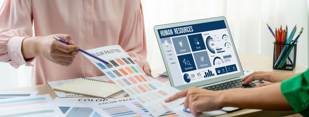 Human resources management software on computer screen helping human resources employee to manage recruitment, payroll, staff searching and KPI evaluation brisk