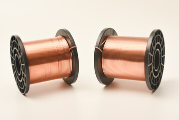 Copper coils on a white background. Copper wire for electronics. Pure copper.