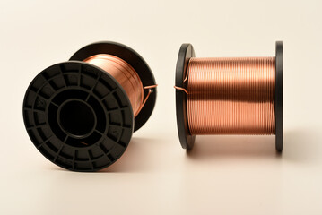 Copper coils on a white background. Copper wire for electronics. Pure copper.