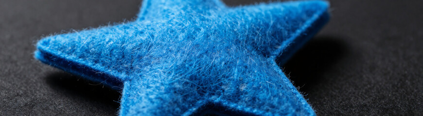 blue felt star shape softly illuminated cinematic lighting revealing intricate textures fibers subtle wispy edges blur