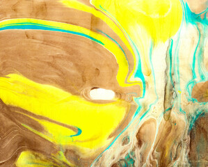 Handmade organic fluid art natural earth tones yellow turquoise abstract marble texture. 