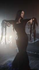 Femme fatale in gothic black dress with corset, elegant dark interior portrait.