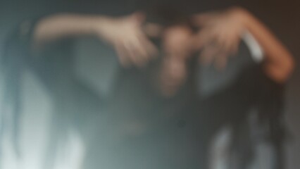 Femme fatale in gothic black dress with corset, elegant dark interior portrait.