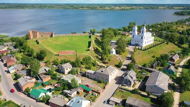 Aerial 4K video from a drone of the city of Ludza. In the background, the Ludza Medieval Castle, the city's churches, and lakes are visible on a sunny summer day. Ludza, Latgale, Latvia. 