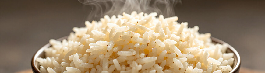 steaming bowl cooked basmati rice showcases soft fluffy grains warm golden light neutral background inviting viewer