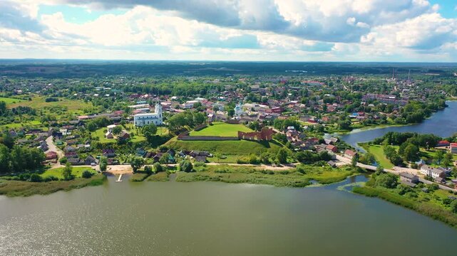 Aerial 4K video from a drone of the city of Ludza. In the background, the Ludza Medieval Castle, the city's churches, and lakes are visible on a sunny summer day. Ludza, Latgale, Latvia. 