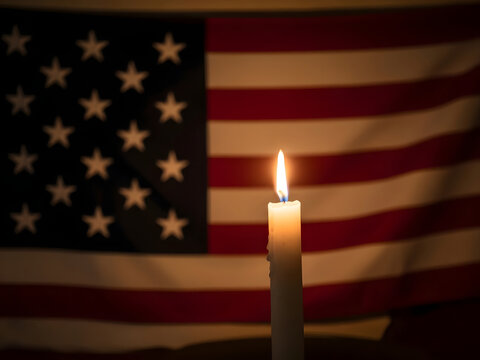 American flag with a lit candle on national day