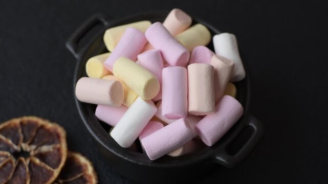 Mini marshmallows in white, pink, and pastel colors, a colorful Christmas dessert. Marshmallows as a food background for your design