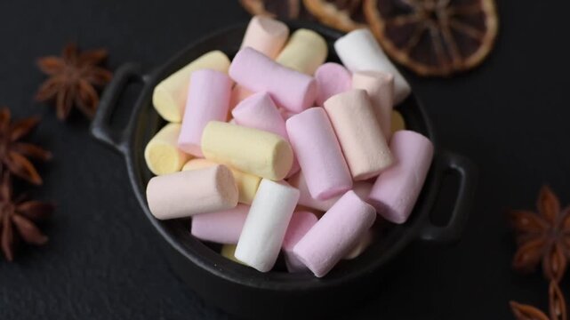 Mini marshmallows in white, pink, and pastel colors, a colorful Christmas dessert. Marshmallows as a food background for your design