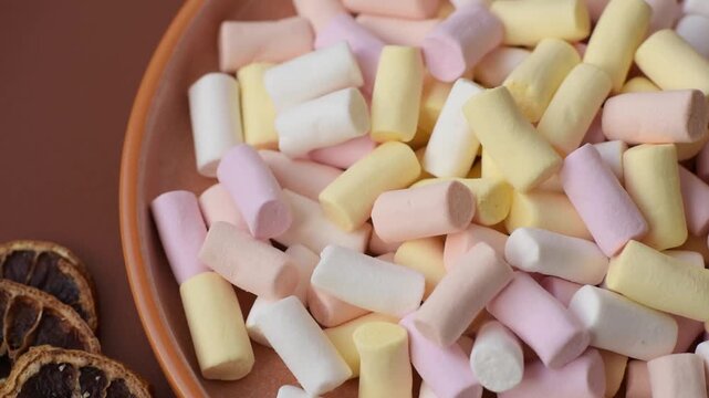 Mini marshmallows in white, pink, and pastel colors, a colorful Christmas dessert. Marshmallows as a food background for your design