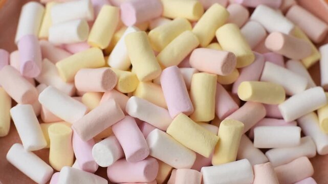 Mini marshmallows in white, pink, and pastel colors, a colorful Christmas dessert. Marshmallows as a food background for your design