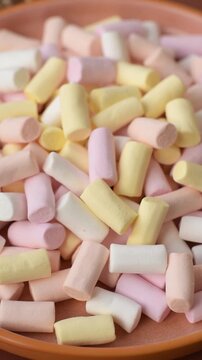 Mini marshmallows in white, pink, and pastel colors, a colorful Christmas dessert. Marshmallows as a food background for your design