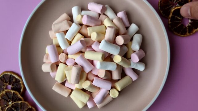 Mini marshmallows in white, pink, and pastel colors, a colorful Christmas dessert. Marshmallows as a food background for your design