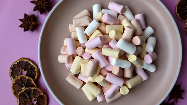 Mini marshmallows in white, pink, and pastel colors, a colorful Christmas dessert. Marshmallows as a food background for your design