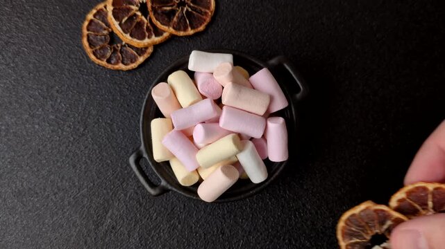 Mini marshmallows in white, pink, and pastel colors, a colorful Christmas dessert. Marshmallows as a food background for your design